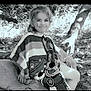 Mélina participe au concours pour gagner de l'argent avec cette photo : blanket, cartoon_character, casual, child, clothing, face, forest, grass, happy, nature, outdoor, person, poncho, portrait, relaxed, sitting, smiling, sunlight, tree, young