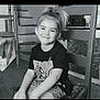 Mélina participe au concours pour gagner de l'argent avec cette photo : black_and_white, casual_clothing, chair, child, cute, furniture, happy, home, indoor, kid, person, ponytail, portrait, relaxed, seated, shorts, smile, stairs, tshirt, young