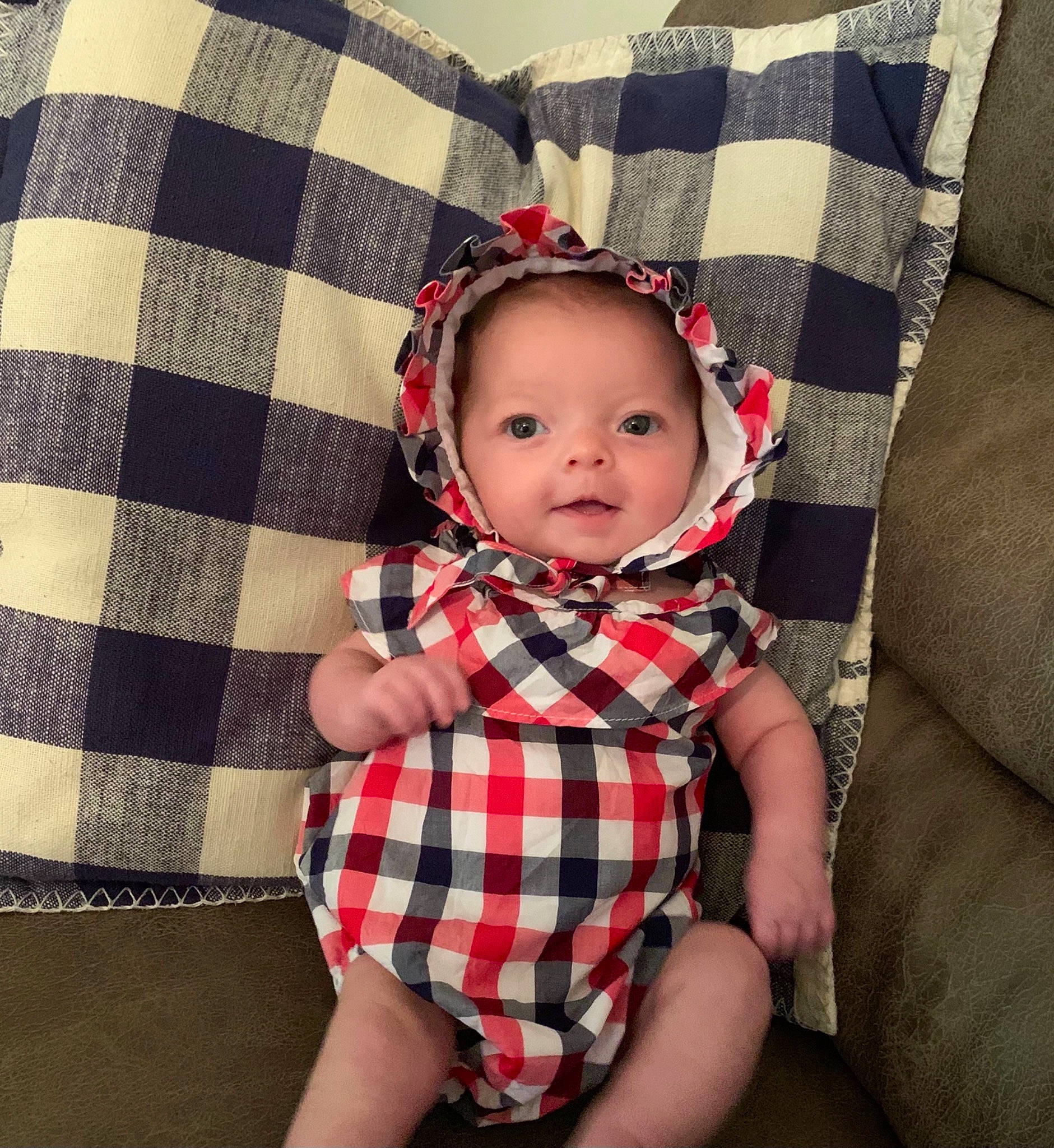 Ellie is registered to the contest to win money with this photo: baby, baby_toddler_clothing, collar, costume_hat, dress, eye, face, lip, outerwear, pattern, person, pink, plaid, plant, red, skin, sleeve, tartan, textile, toddler