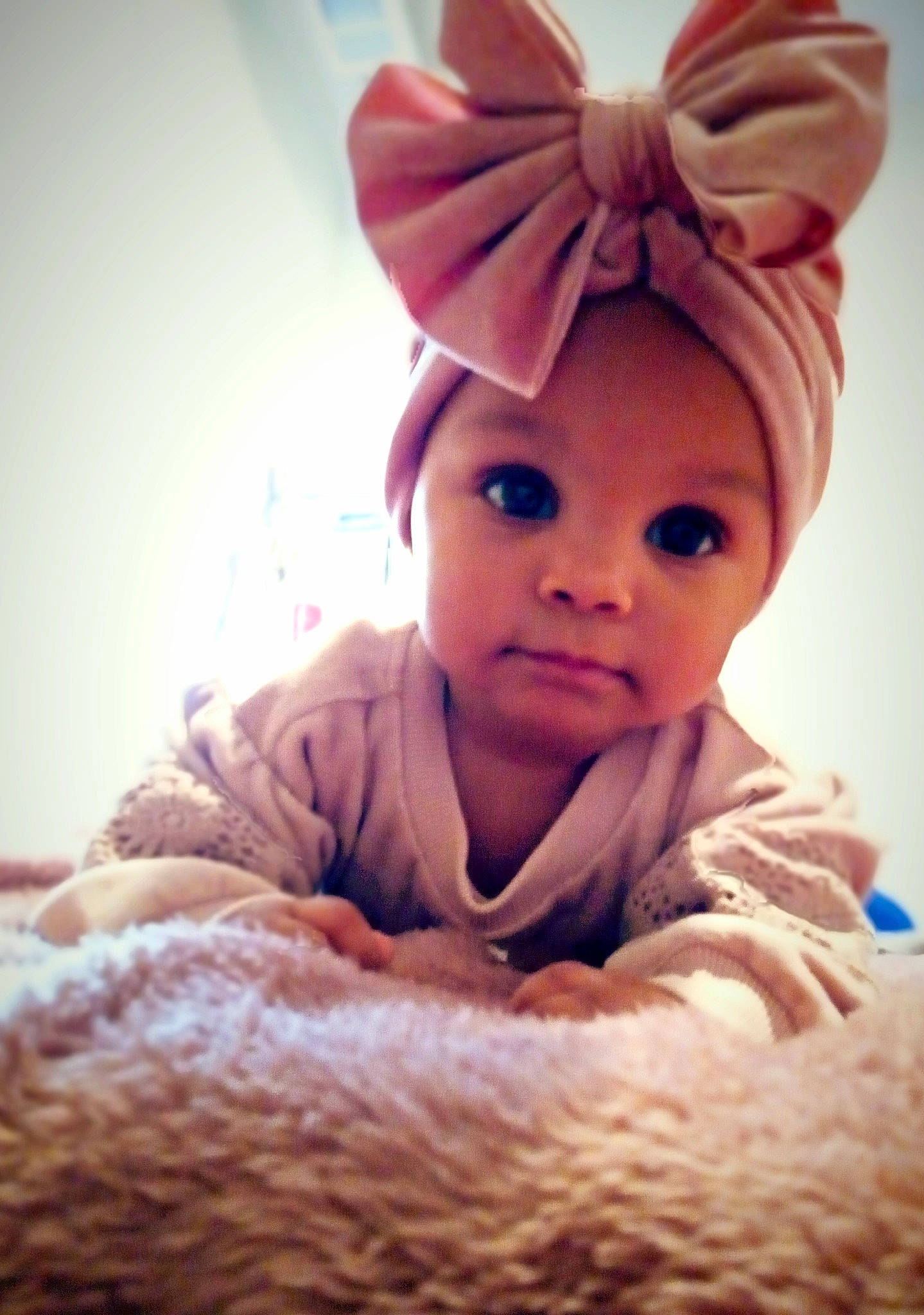 Raeja is registered to the contest to win money with this photo: baby, baby_sleeping, bedding, cap, child, comfort, facial_expression, fur, gesture, happy, knit_cap, linens, magenta, nose, person, pink, room, skin, sleeve, smile