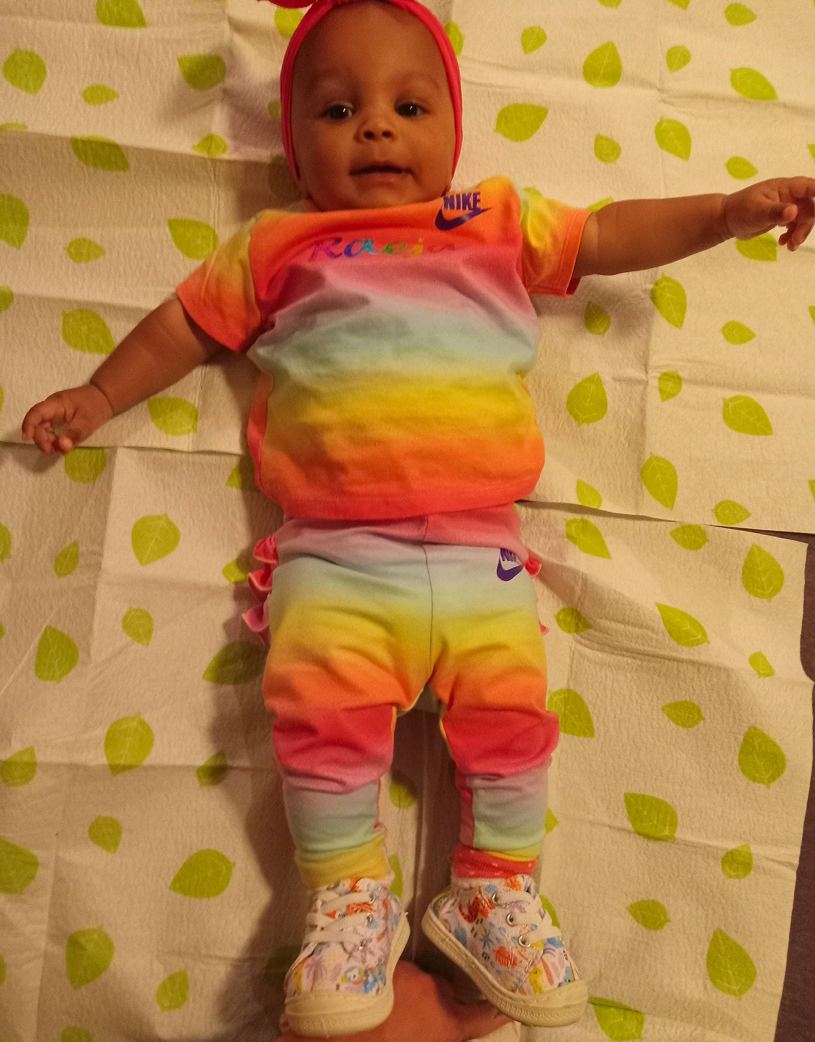 Raeja is registered to the contest to win money with this photo: baby, baby_safety, baby_toddler_clothing, cheek, child, face, gesture, happy, head, nose, pattern, person, pink, product, skin, sleeve, smile, standing, textile, toddler