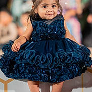 Reya joined the competition — help win amazing prizes! toddler, child, dress, blue_dress, smiling, portrait, fashion, cute, happy, sitting, hair_bun, barefoot, indoor, person, face, young_child, elegant, decorative, event, photography