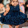 toddler, child, dress, blue_dress, smiling, portrait, fashion, cute, happy, sitting, hair_bun, barefoot, indoor, person, face, young_child, elegant, decorative, event, photography