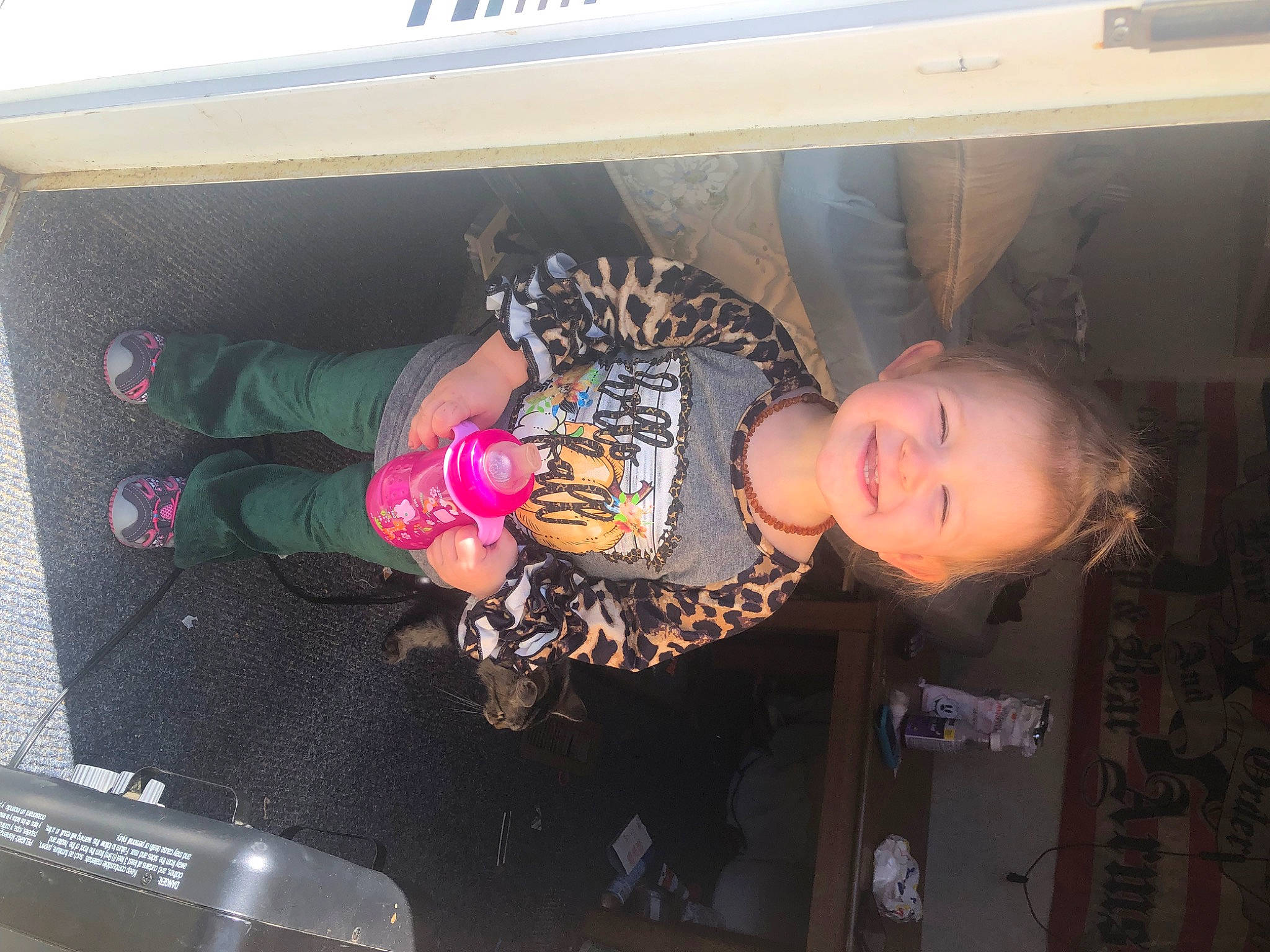 Braelyn is registered to the contest to win money with this photo: automotive_exterior, bumper, fun, joy, motor_vehicle, person, pink, smile, trunk, vehicle, vehicle_door