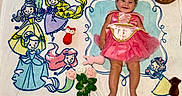Scarlett joined the competition — help win amazing prizes! baby, princess_dress, tiara, smiling, blanket, cartoon_princesses, toys, roses, month_marker, pink, blue, yellow, green, happy, child, floor, cute, celebration, portrait, infant