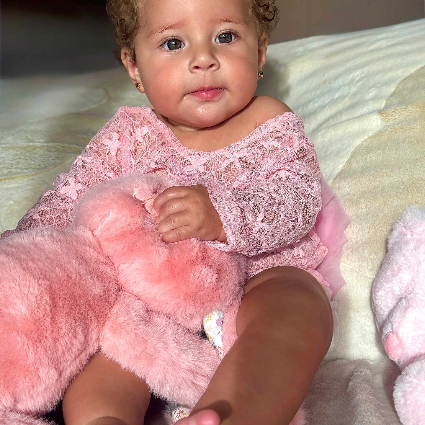 Scarlett is registered to the contest to win money with this photo: baby, child, pink, lace, bow, stuffed_animal, plush, blanket, soft_texture, cute, portrait, sitting, indoors, happy, toddler, clothing, feet, face, earrings, toy
