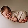 newborn, baby, sleeping, infant, knitted_outfit, beige, soft_texture, peaceful, portrait, closeup, cute, tiny_hands, tiny_feet, resting, neutral_background, cozy, child, smooth_skin, head, face