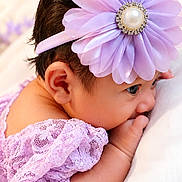 Tviya is registered to the contest to win money with this photo: baby, infant, purple_flower, headband, lace_clothing, side_profile, soft_surface, cute, newborn, sleepy, tiny_hand, closeup, portrait, child, adorable, resting, soft_lighting, delicate, skin, young