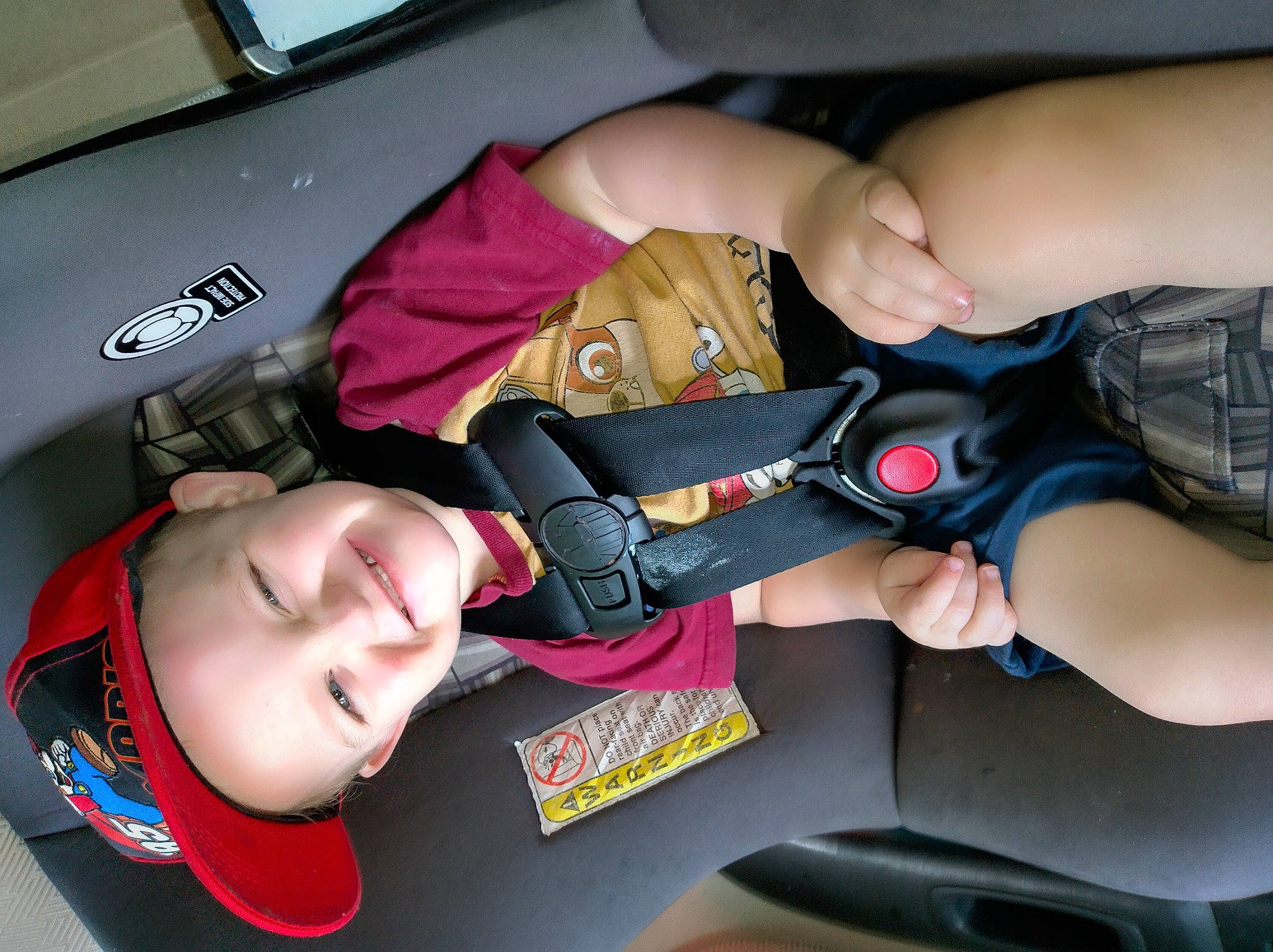 Brysten joined the competition — help win amazing prizes! auto_part, automotive_design, automotive_exterior, baby_in_car_seat, car_seat, comfort, electric_blue, finger, gesture, hand, headwear, human_leg, joy, motor_vehicle, mouth, nail, person, seat_belt, thumb, toddler