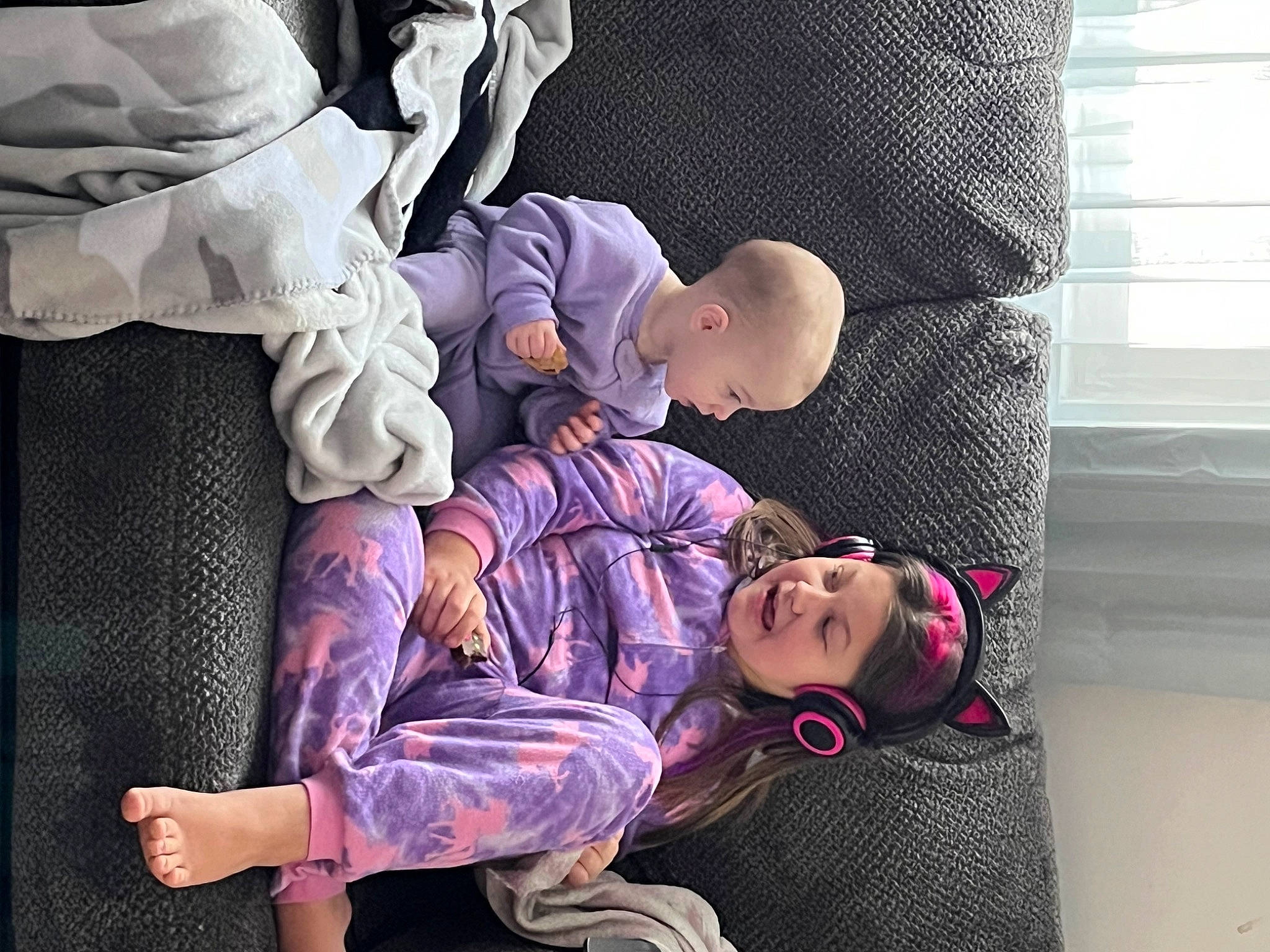 Kayla joined the competition — help win amazing prizes! baby, child, comfort, curtain, entertainment, event, fun, lap, leg, magenta, pattern, performing_arts, person, purple, room, sitting, toddler, window_blind, window_treatment