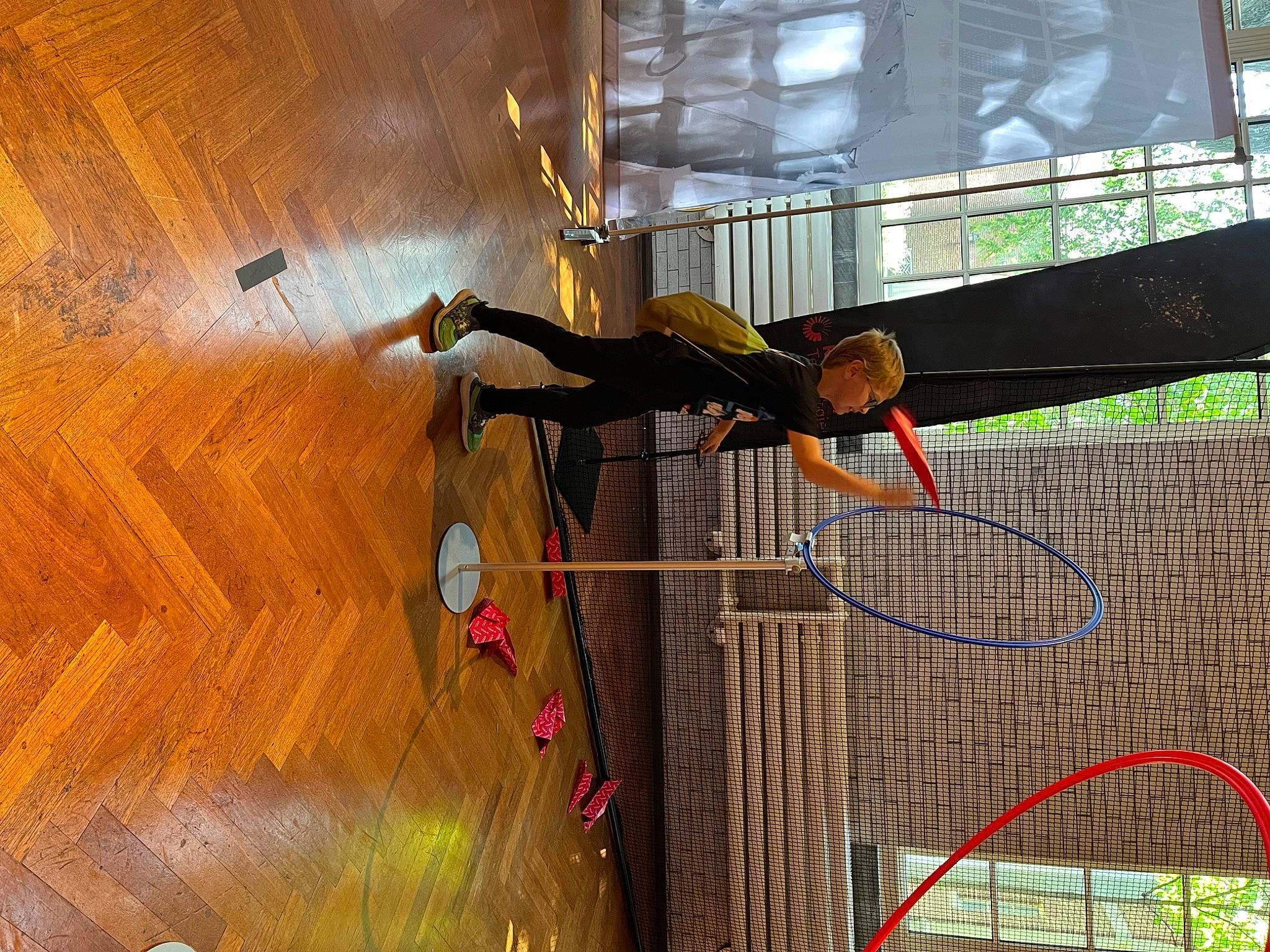 Zac is registered to the contest to win money with this photo: adventure, balance, entertainment, event, flooring, footwear, fun, hardwood, leisure, line, performing_arts, person, plywood, recreation, rope, sports, varnish, wire, wood, wood_flooring