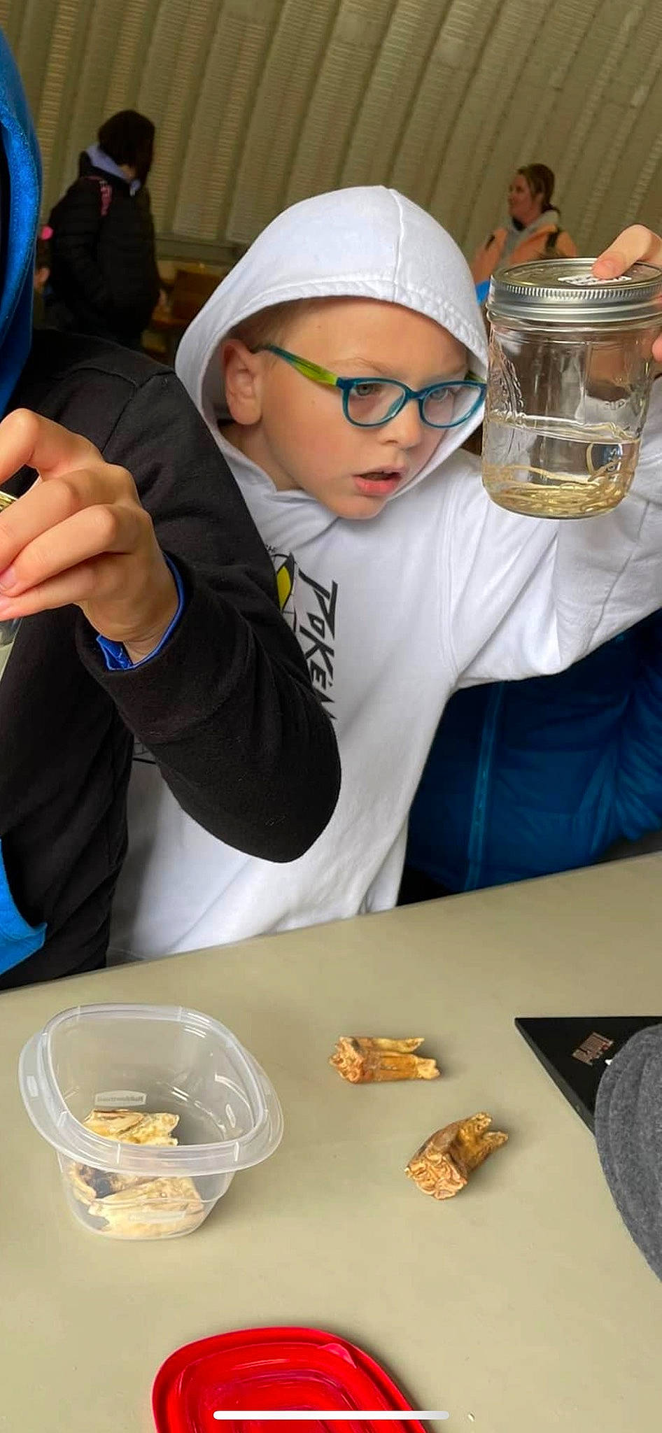 Zac is registered to the contest to win money with this photo: chair, comfort_food, cooking, cuisine, dish, event, eyewear, finger_food, food, goggles, headwear, job, person, personal_protective_equipment, plate, recreation, room, science, sunglasses, table