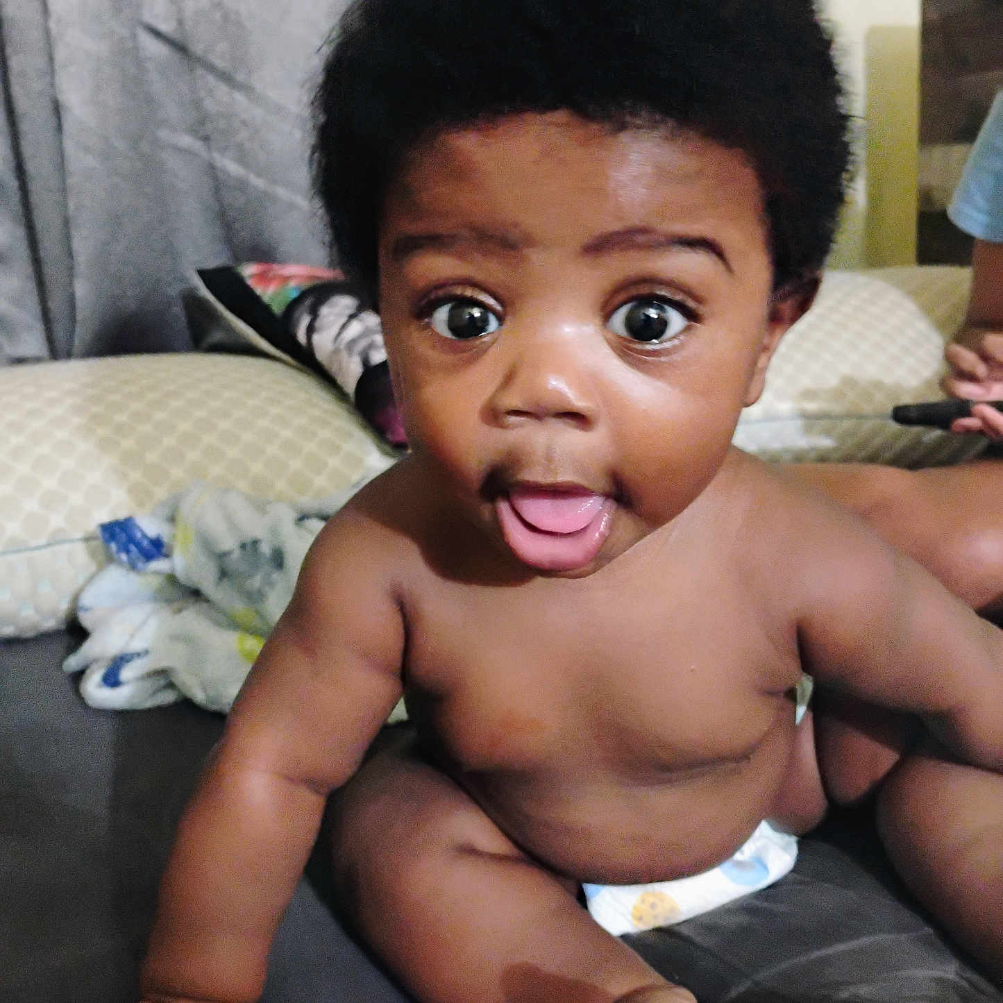 Artist is registered to the contest to win money with this photo: baby, babylaughing, back, blackhair, bodypart, couch, face, finger, furniture, hair, hand, happy, head, mouth, person, photography, portrait, sitting, smile, tongue