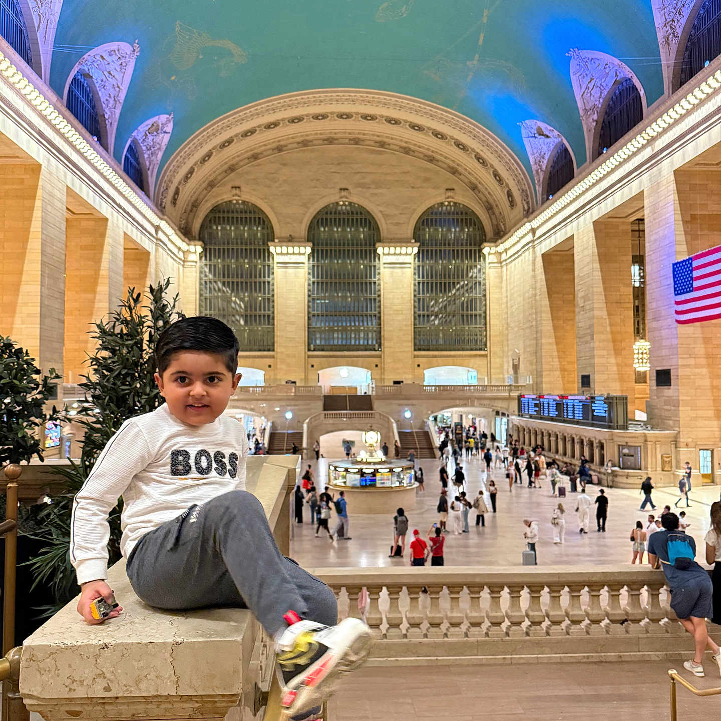 Muhammad Buraq joined the competition — help win amazing prizes! child, boy, indoor, grand_central_station, architecture, marble, railing, people, crowd, ceiling, lighting, clothing, sneakers, casual, playful, urban, tourist, portrait, smile, public_space