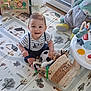 Noé a rejoint le concours — aidez-le/la à gagner de superbes lots ! baby, child, smiling, striped_shirt, suspenders, soccer_ball, toys, plush_bear, play_mat, indoor, window, natural_light, activity_table, floor, basket, happy, cute, sitting, person, home
