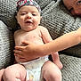 Huxley joined the competition — help win amazing prizes! arm, baby, bandana, blanket, child, closeup, comfort, couch, diaper, expression, face, hand, happy, indoor, person, plush, relax, sibling, skin, smile