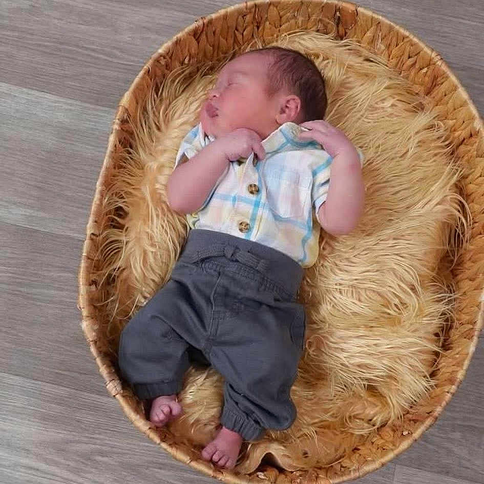 Huxley joined the competition — help win amazing prizes! baby, basket, child, clothing, cozy, cute, floor, fluffy, indoors, infant, newborn, pants, peaceful, person, plaid_shirt, portrait, resting, sleeping, soft, wooden_floor