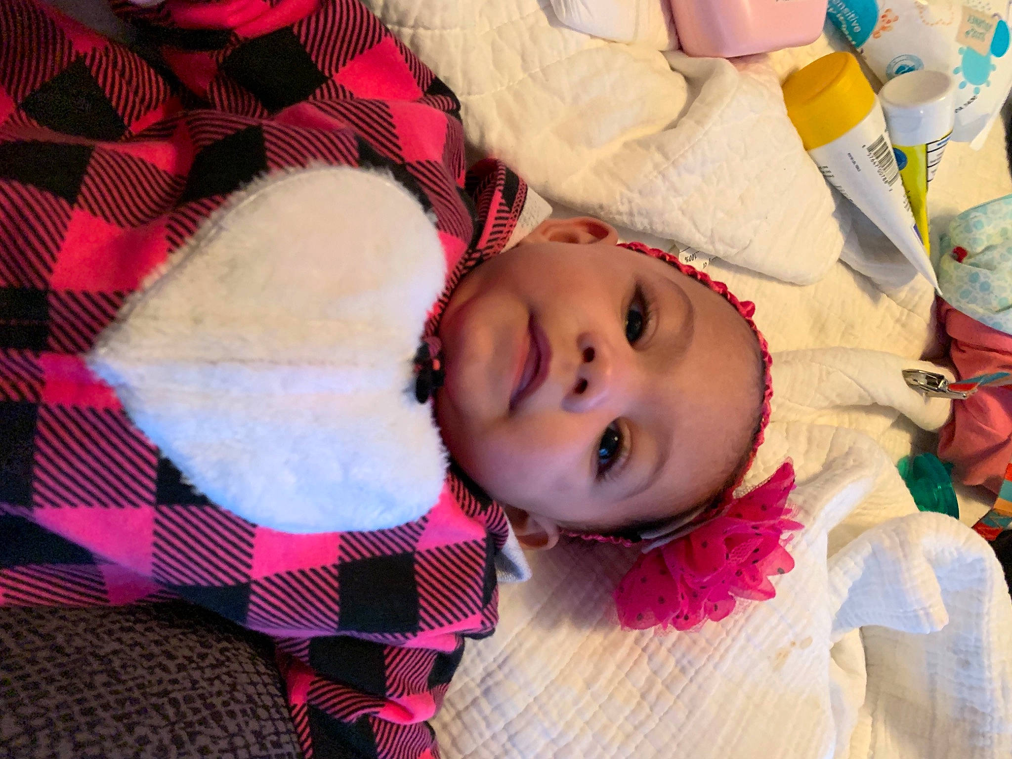 Jada is registered to the contest to win money with this photo: baby, baby_toddler_clothing, cheek, chin, eye, eyelash, happy, head, headgear, headwear, iris, lip, mouth, nose, pattern, person, pink, plaid, skin, tartan