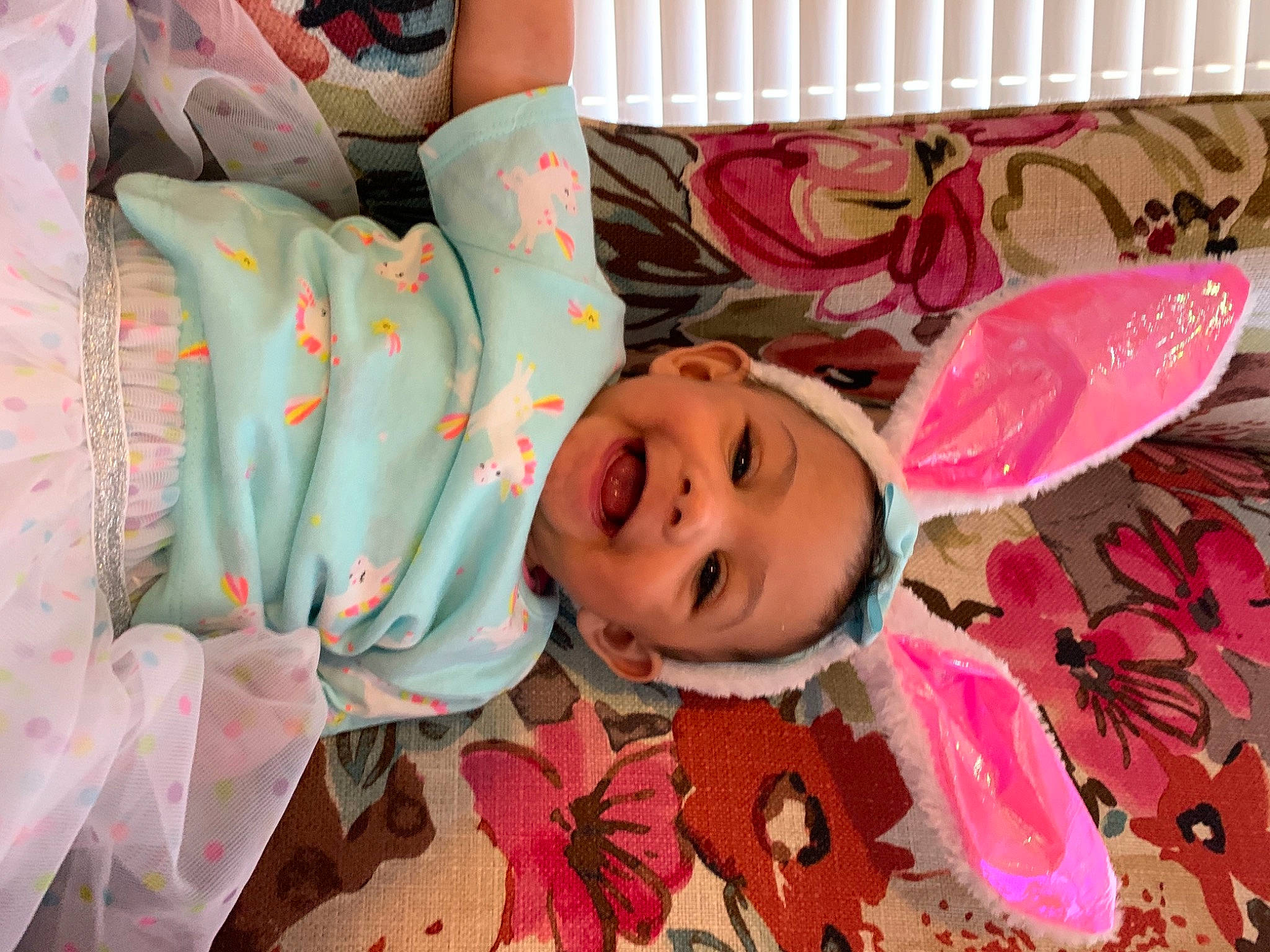 Jada is registered to the contest to win money with this photo: baby, cheek, child, comfort, eye, face, fun, happy, head, human_body, linens, mammal, mouth, pattern, person, petal, pink, skin, smile, textile