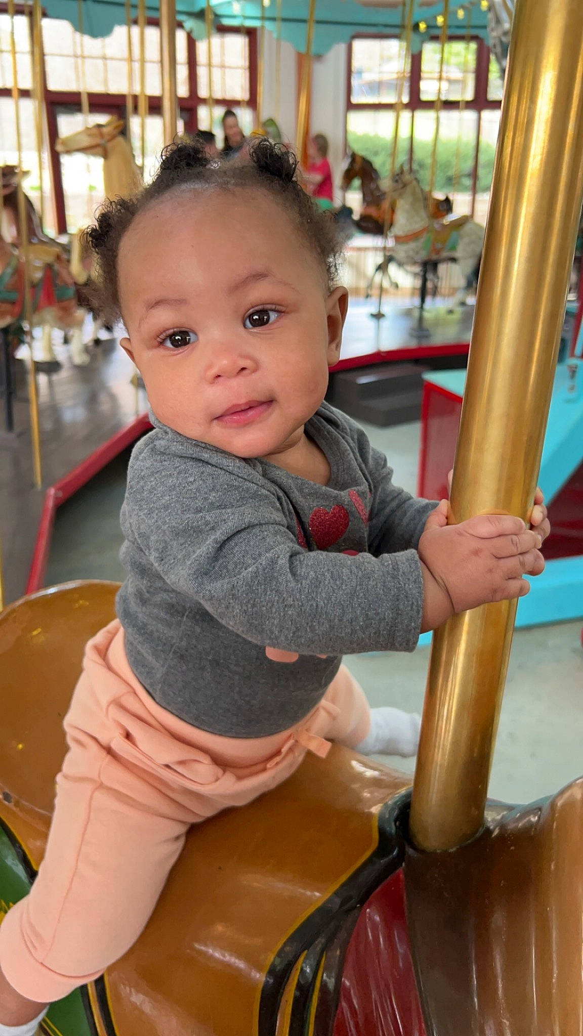 Clover is registered to the contest to win money with this photo: baby, baby_toddler_clothing, cheek, child, chute, city, flooring, fun, happy, leisure, people, person, play, product, public_space, recreation, sitting, skin, standing, toddler