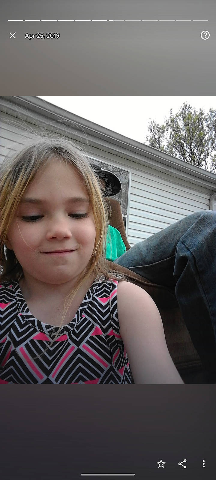 Emery is registered to the contest to win money with this photo: bangs, brown_hair, cool, eyebrow, eyelash, feathered_hair, flash_photography, fun, grass, hair, happy, jewellery, joy, layered_hair, lip, long_hair, pattern, person, sitting, t_shirt