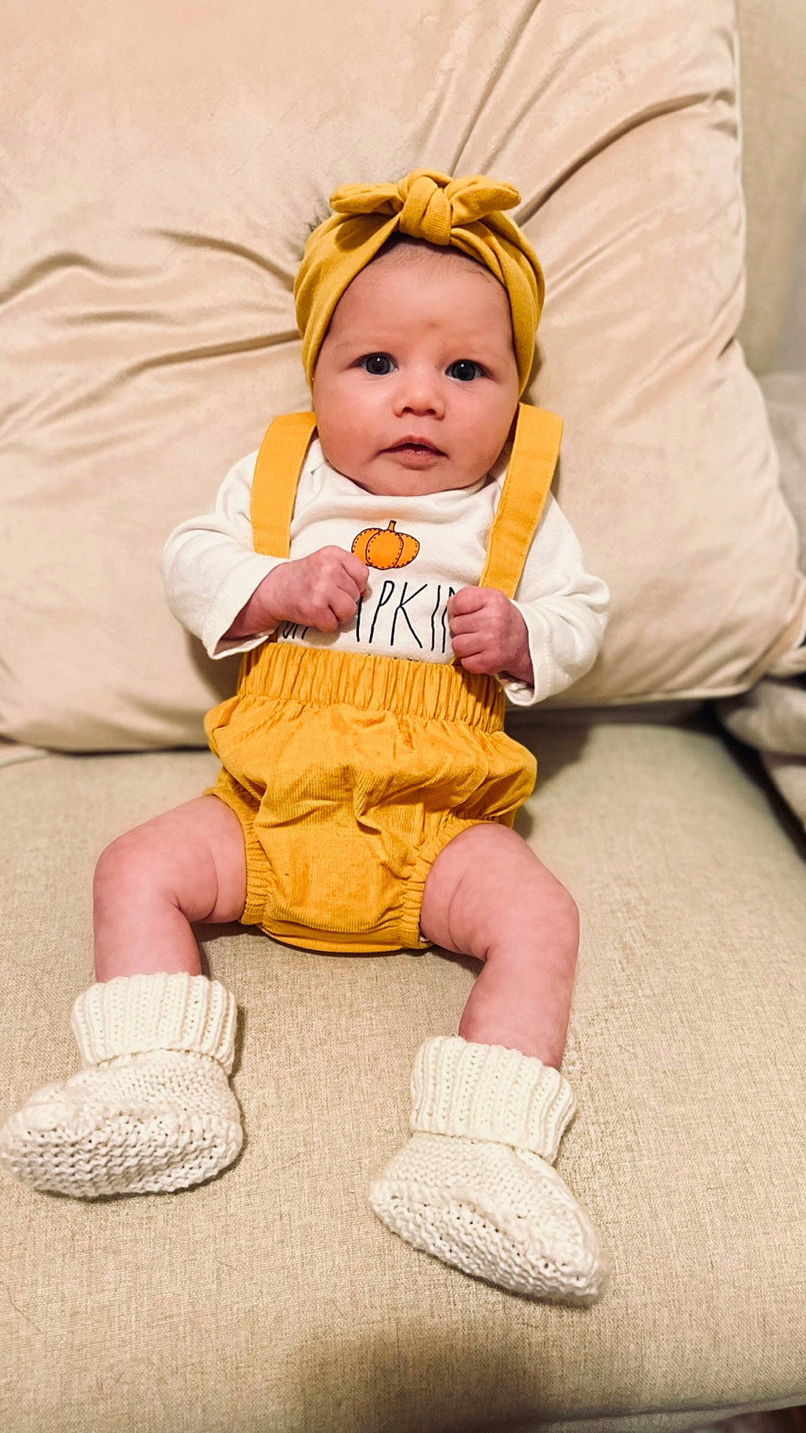 Fiona is registered to the contest to win money with this photo: baby, baby_products, baby_toddler_clothing, cheek, child, comfort, eye, face, finger, fun, happy, head, headwear, human_leg, knee, person, sitting, skin, sleeve, sock