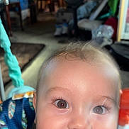 Kingston is registered to the contest to win money with this photo: baby, child, face, smile, teeth, eyes, skin, hair, clothing, indoor, blanket, pattern, furniture, fan, person, portrait, happy, closeup, infant, living_room