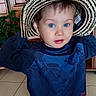 Leo participe au concours pour gagner de l'argent avec cette photo : blue_eyes, bright_eyes, casual_clothing, child, close_up, curious, cute, hair, hands_up, hat_tag, houseplant, indoor, playful, portrait, straw_hat, sweater, tiled_floor, toddler, wet_spot, wooden_cabinet