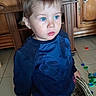 Leo a rejoint le concours — aidez-le/la à gagner de superbes lots ! basket, blue_eyes, boy, casual_clothing, child, curious_expression, face, hands, home_interior, indoor, natural_light, navy_sweater, plastic_caps, portrait, scattered_toys, short_hair, standing, tiled_floor, toddler, wooden_cabinet