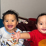 Isaiah-Isaac is registered to the contest to win money with this photo: toddler, child, smiling, playful, bed, blanket, pajamas, indoor, happy, cute, person, face, expression, clothing, room, furniture, young_child, portrait, two_children, home