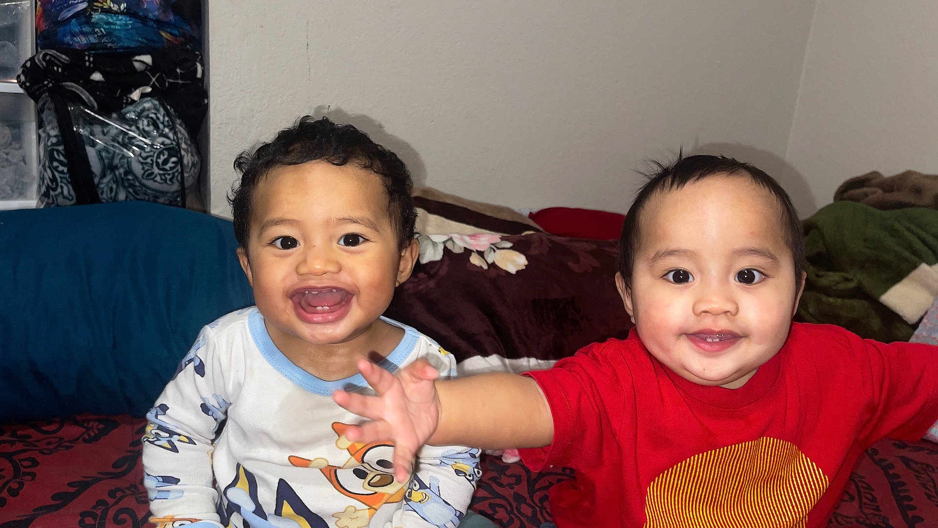 Isaiah-Isaac is registered to the contest to win money with this photo: toddler, child, smiling, playful, bed, blanket, pajamas, indoor, happy, cute, person, face, expression, clothing, room, furniture, young_child, portrait, two_children, home