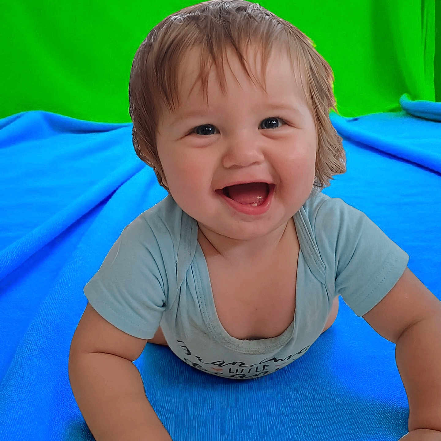 Keith is registered to the contest to win money with this photo: baby, blue_blanket, child, clothing, crawling, cute, expression, eyes, face, green_background, hand, happy, indoor, infant, mouth, portrait, short_hair, skin, smiling, toddler