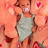 Meadow is registered to the contest to win money with this photo: baby, infant, pacifier, stuffed_toy, plush, pink, blanket, strawberry, cute, child, soft, bed, toy, lying_down, sleepwear, comfort, small, adorable, cozy, fabric