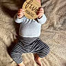 Koa joined the competition — help win amazing prizes! baby, infant, child, five_months, milestone_photo, wooden_sign, handmade_sign, striped_pants, gray_shirt, long_sleeves, bare_feet, carpet, lying_down, indoor, top_down, cozy, parenting, baby_clothing, photography, text