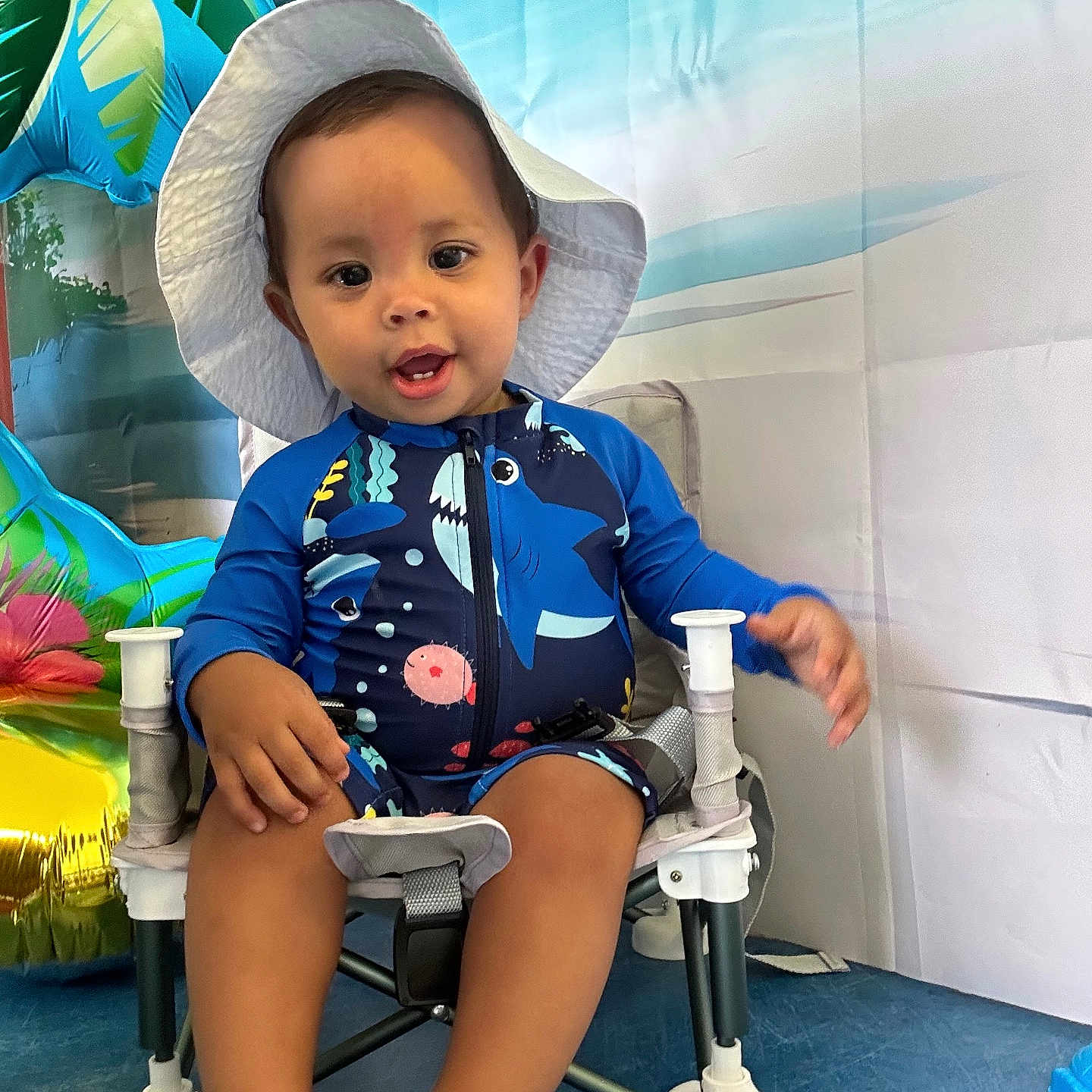 Castilla Thiago a rejoint le concours — aidez-le/la à gagner de superbes lots ! baby, background, blue, chair, child, cute, footwear, hat, indoor, inflatable, person, playful, portrait, seat, smiling, summer, swimsuit, toddler, tropical, white