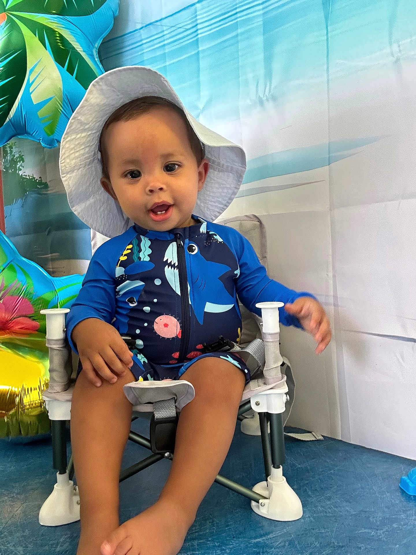 Castilla Thiago a rejoint le concours — aidez-le/la à gagner de superbes lots ! baby, background, blue, chair, child, cute, footwear, hat, indoor, inflatable, person, playful, portrait, seat, smiling, summer, swimsuit, toddler, tropical, white