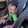 Nolan joined the competition — help win amazing prizes! baby, child, car_seat, smiling, green_clothing, dinosaur_print, car_interior, sunset_light, happy, infant, seatbelt, safety, cute, portrait, indoors, seat, head_support, toy, playful, people