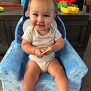 Nolan is registered to the contest to win money with this photo: baby, carpet, casual, child, colorful, cracker, cute, furniture, happy, home, indoor, infant, person, playtime, plush_chair, relaxed, smiling, toys, water_bottle, wooden_table