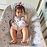 Melany is registered to the contest to win money with this photo: baby, child, infant, pink_bow, baby_seat, floral_pattern, straps, curious_eyes, barefoot, indoors, kitchen, floor_tiles, plastic_baby_seat, cute, sitting, portrait, young_child, home, comfortable, toddler