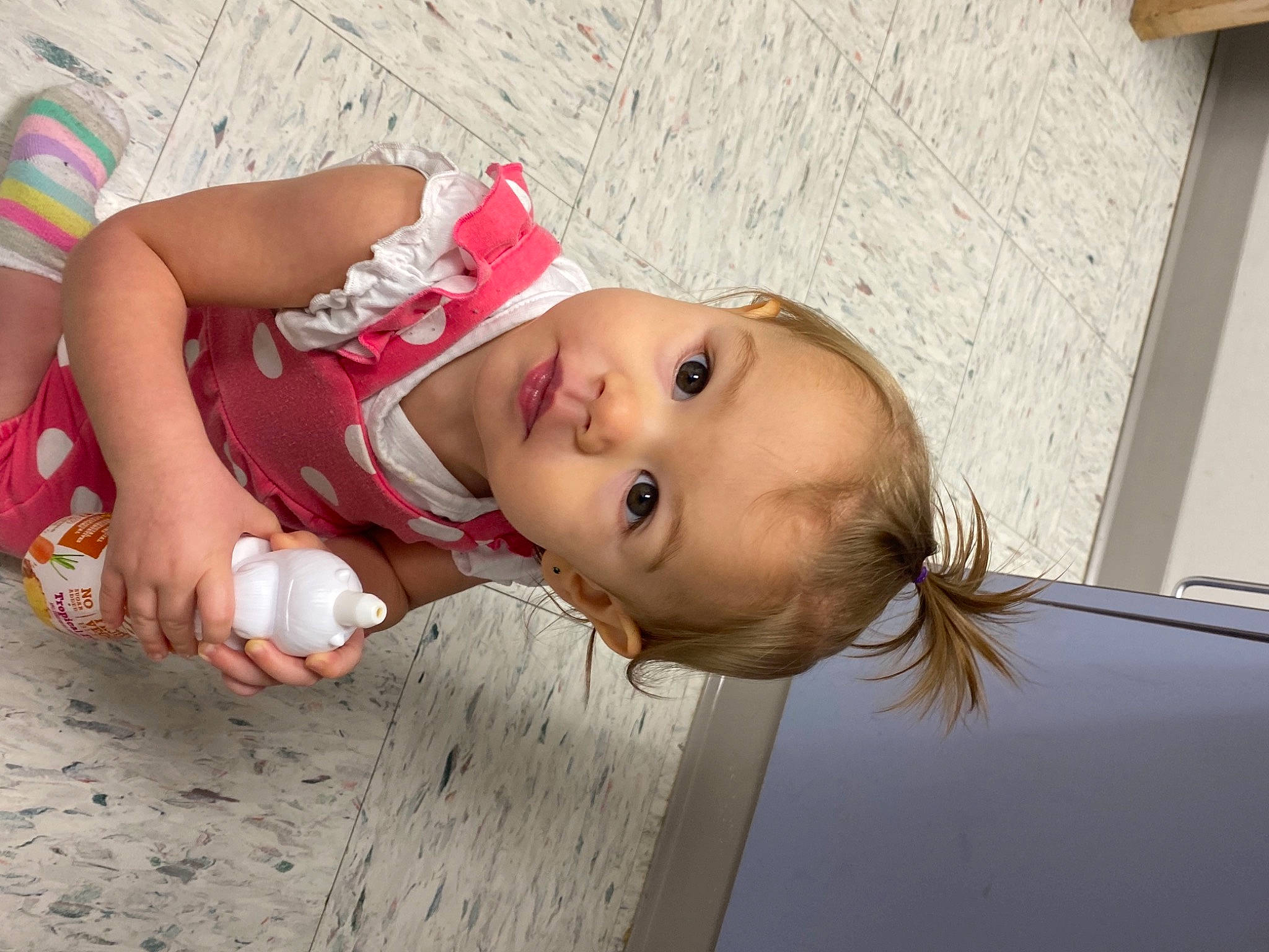 Lorelai is registered to the contest to win money with this photo: baby, baby_toddler_clothing, cheek, child, eye, face, facial_expression, flooring, fun, happy, human, lip, nose, person, portrait_photography, room, sitting, skin, toddler, vacation