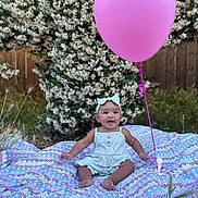 Genesis joined the competition — help win amazing prizes! baby, child, balloon, blanket, outdoor, flowers, greenery, headband, happy, smiling, grass, nature, cute, sitting, summer, playful, patterned_blanket, wooden_fence, sunlight, portrait