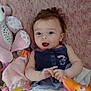 baby, infant, blanket, plush_toy, diaper, clothing, hand, person, soft_toy, blue_eyes, smiling, lying_down, fabric, pink, texture, toy, cute, child, indoor, play