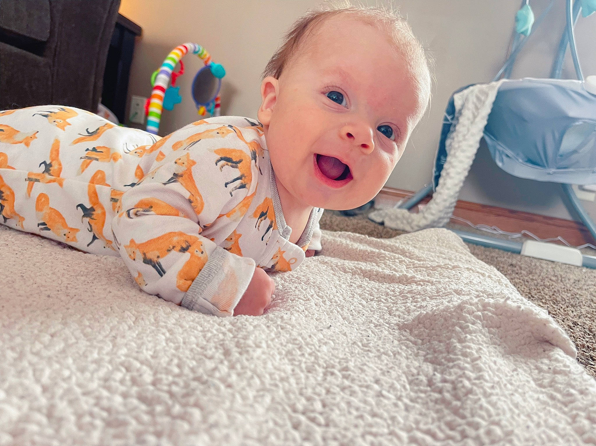 Deacon is registered to the contest to win money with this photo: baby, baby_toddler_clothing, bed, bedding, chair, cheek, child, comfort, flooring, fun, happy, head, linens, nose, orange, person, room, sitting, sleeve, smile