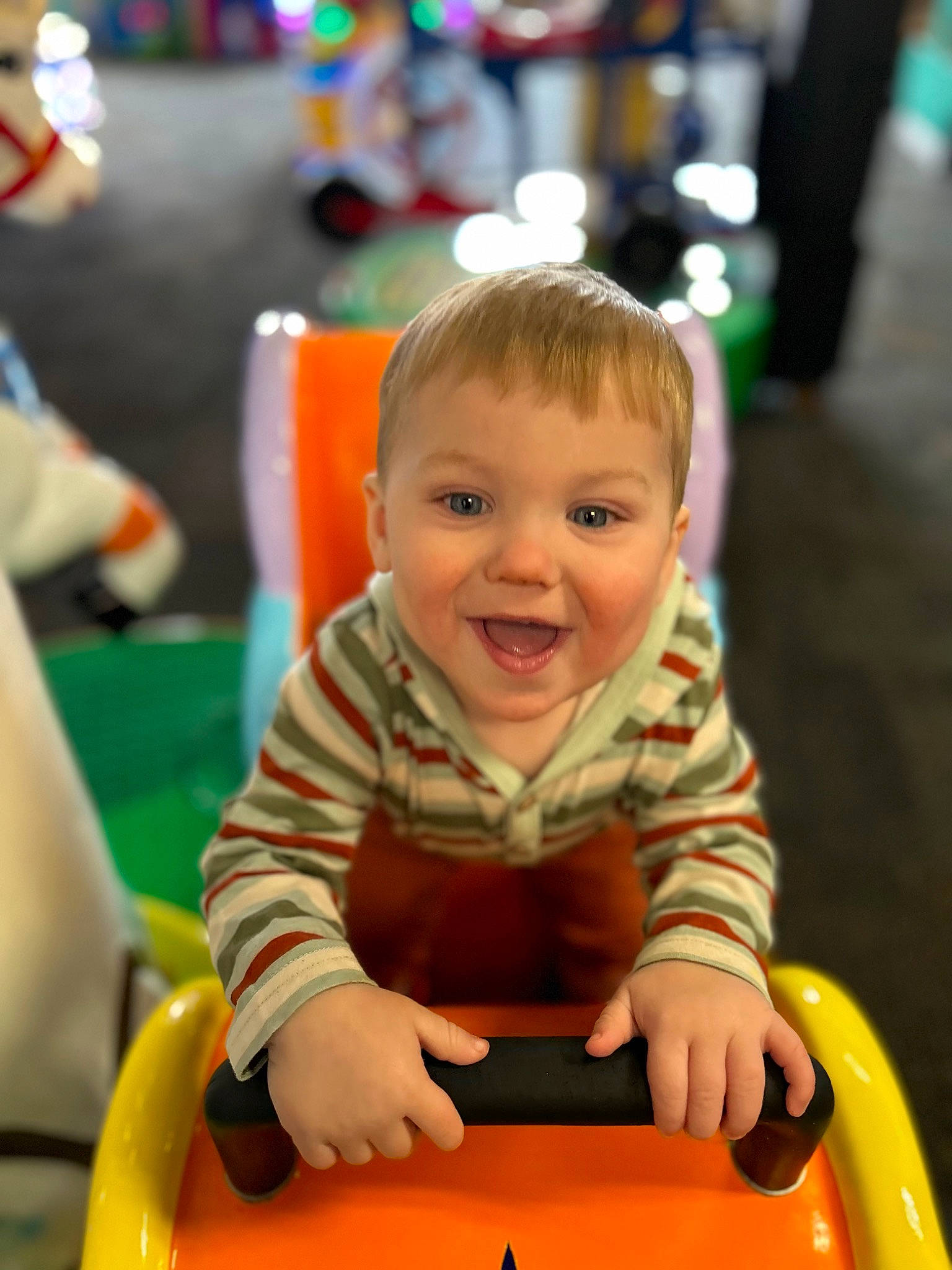 Malakai joined the competition — help win amazing prizes! baby, baby_playing_with_toys, child, event, fun, green, happy, leisure, person, photograph, product, public_space, recreation, riding_toy, sitting, skin, smile, snapshot, toddler, toy