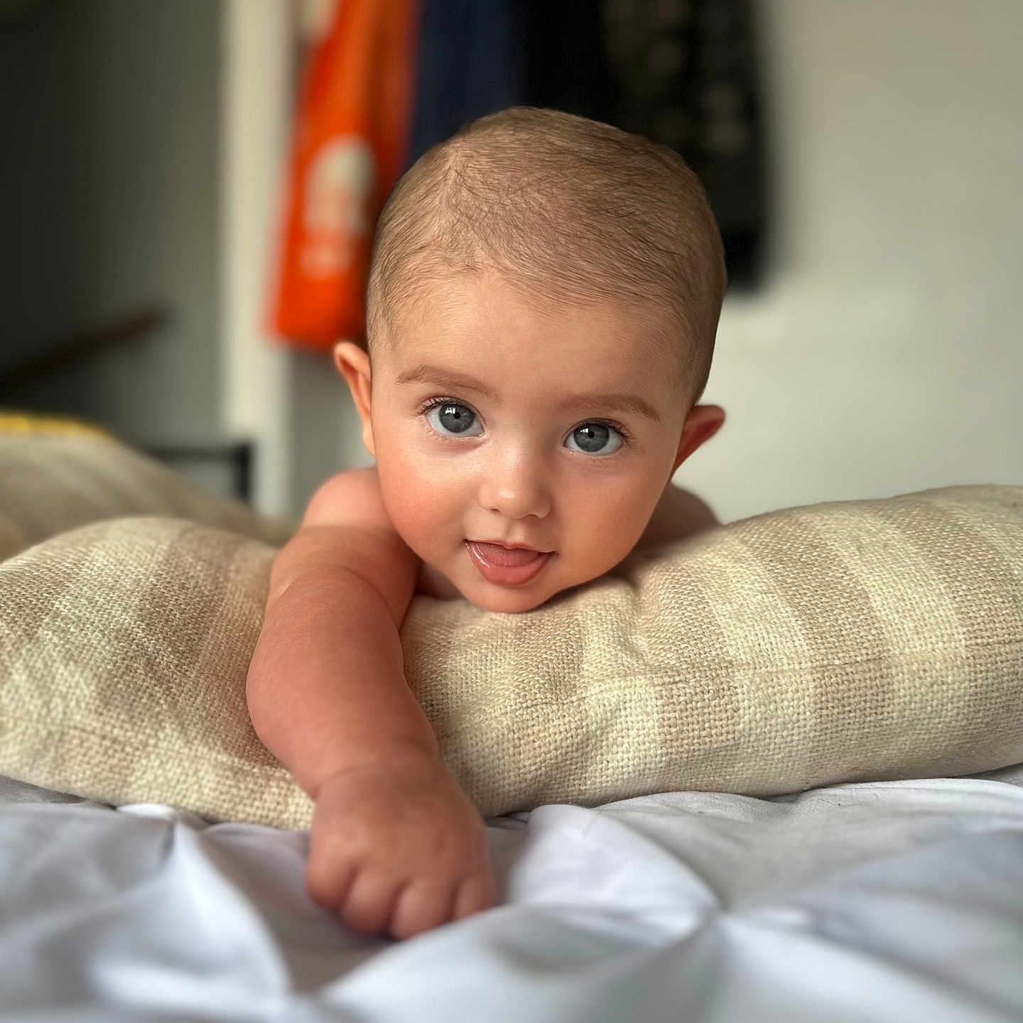 Meliha is registered to the contest to win money with this photo: arm, baby, bed, blanket, blue_eyes, comfort, cute, expression, face, focus, hand, head, indoors, infant, person, pillow, portrait, skin, smiling, young_child