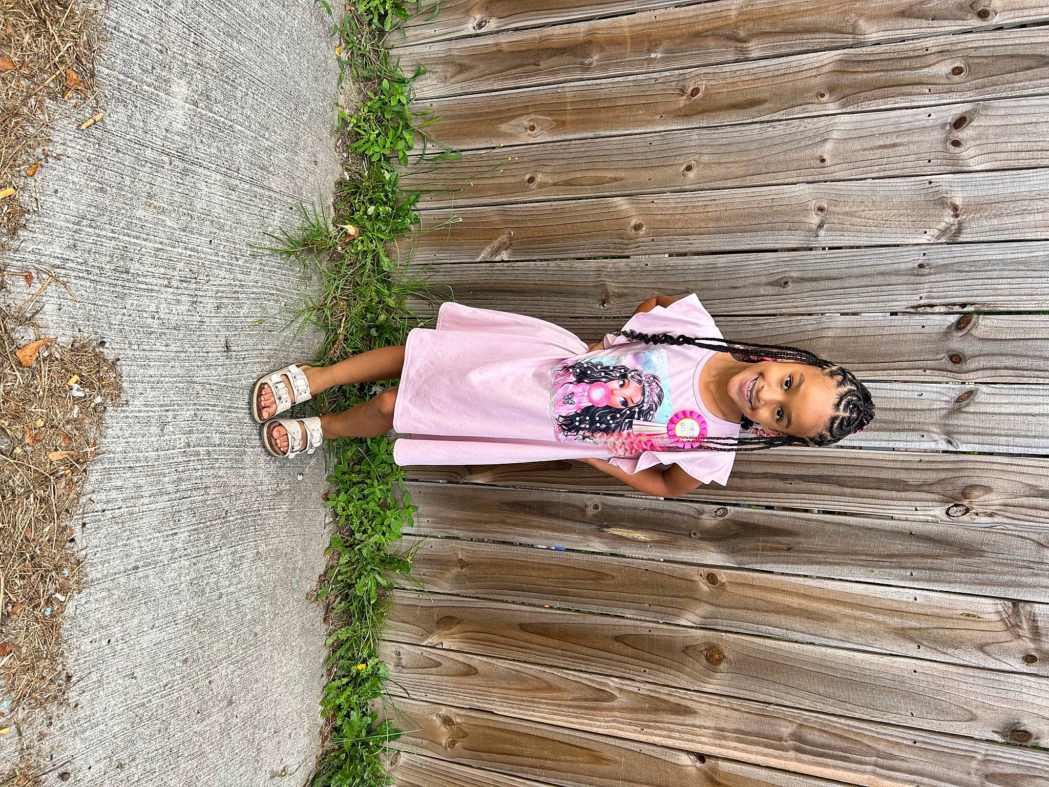 Justice is registered to the contest to win money with this photo: child, dress, grass, happy, hat, human_leg, joy, leaf, leisure, mammal, pattern, people_in_nature, person, plant, road_surface, sitting, spring, toddler, tree, vertebrate