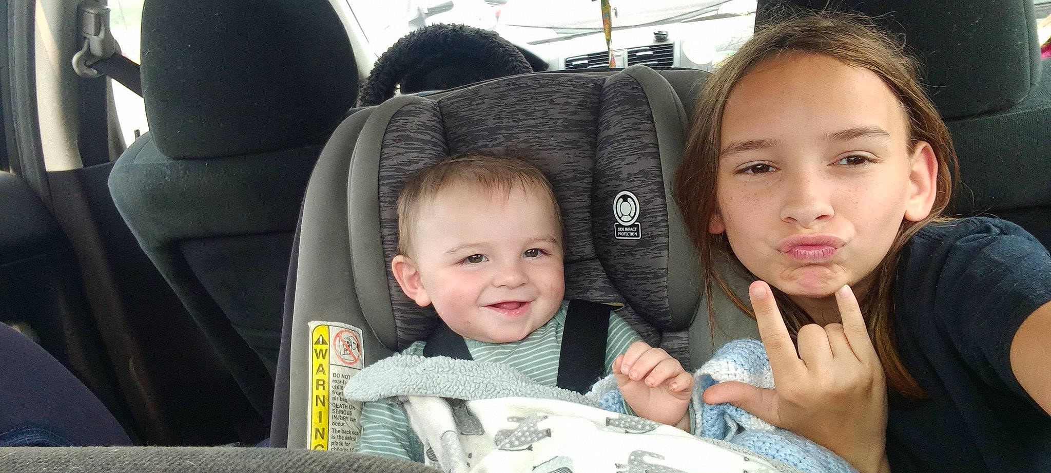 Taylor is registered to the contest to win money with this photo: auto_part, automotive_design, baby, car_seat, car_seat_cover, child, comfort, face, fun, gesture, happy, head, head_restraint, joy, motor_vehicle, person, seat_belt, skin, smile, steering_wheel