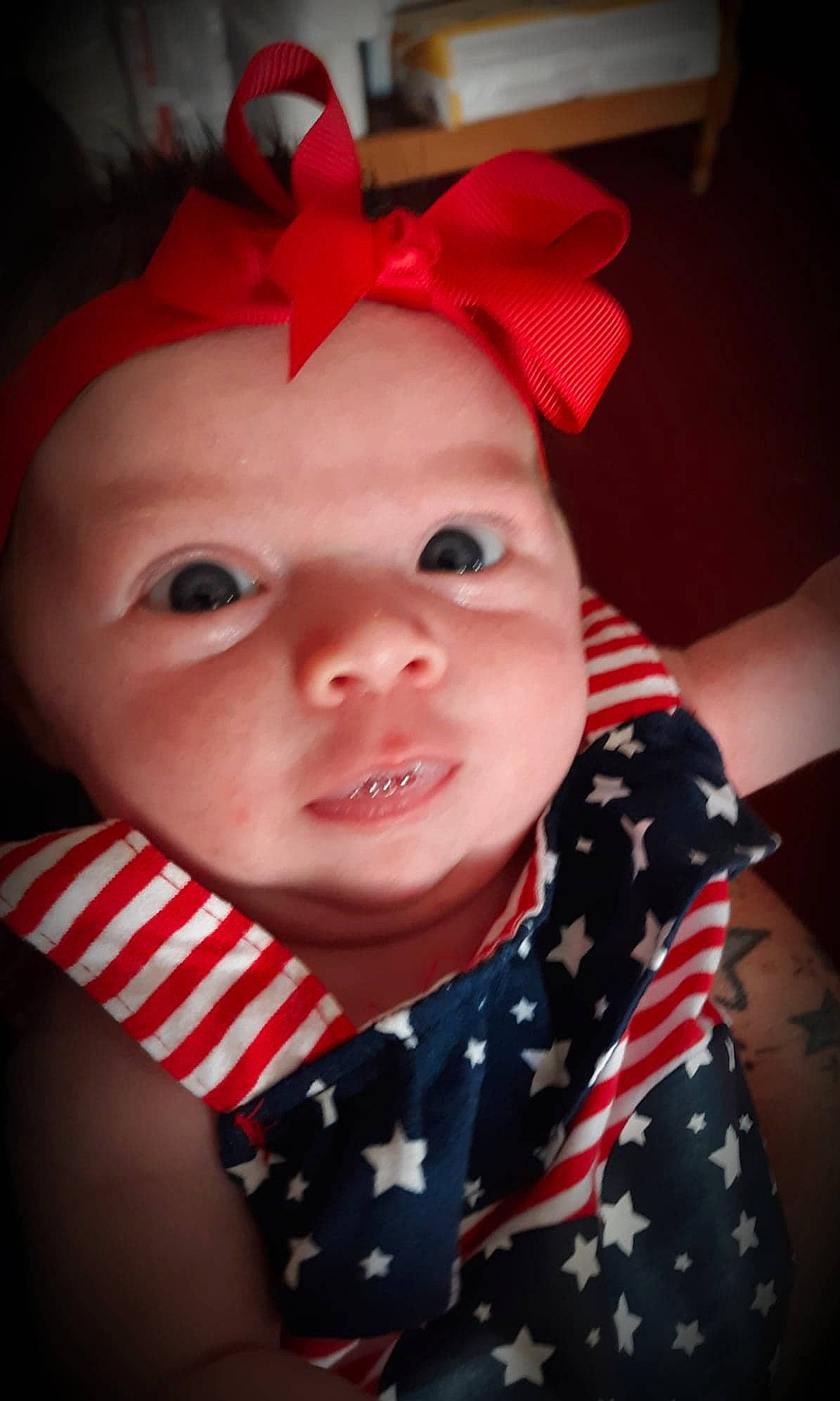 Laynee is registered to the contest to win money with this photo: baby, cheek, child, design, ear, eye, face, hair_accessory, head, headgear, lip, nose, organ, pattern, person, red, skin, smile, toddler