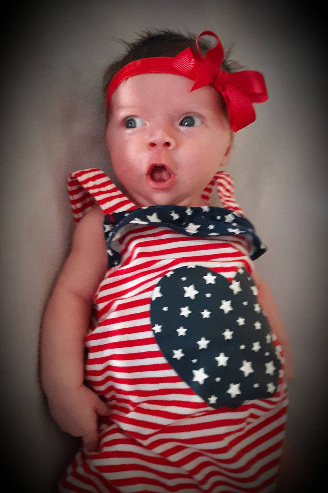 Laynee is registered to the contest to win money with this photo: baby, baby_toddler_clothing, cheek, child, child_model, design, dress, head, lip, pattern, person, photography, portrait_photography, red, toddler