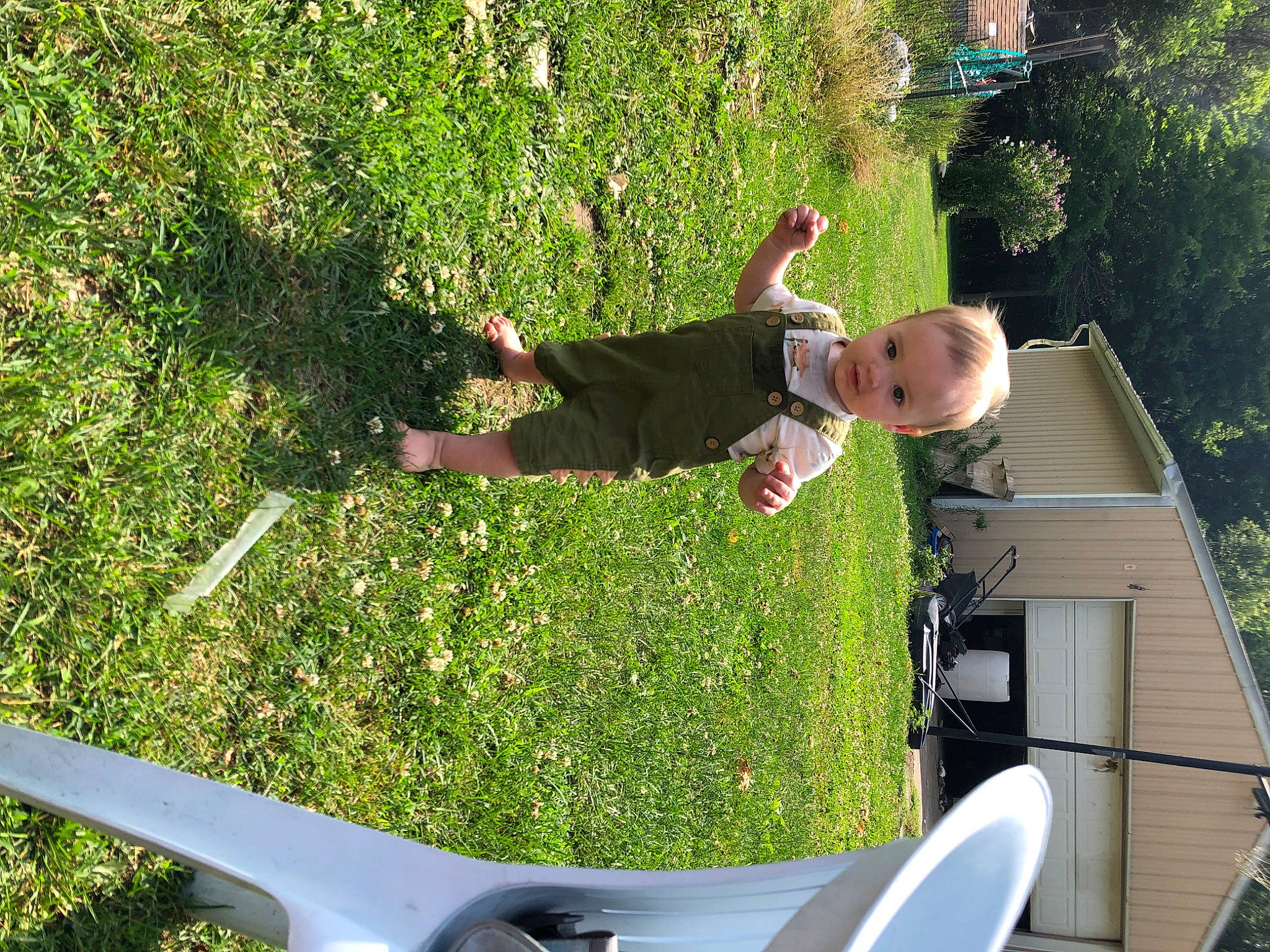 Richard joined the competition — help win amazing prizes! automotive_exterior, backyard, elbow, fun, garden, grass, green, lawn, leisure, light, outdoor_furniture, people_in_nature, person, plant, recreation, shade, shrub, toddler, tree, vehicle_door